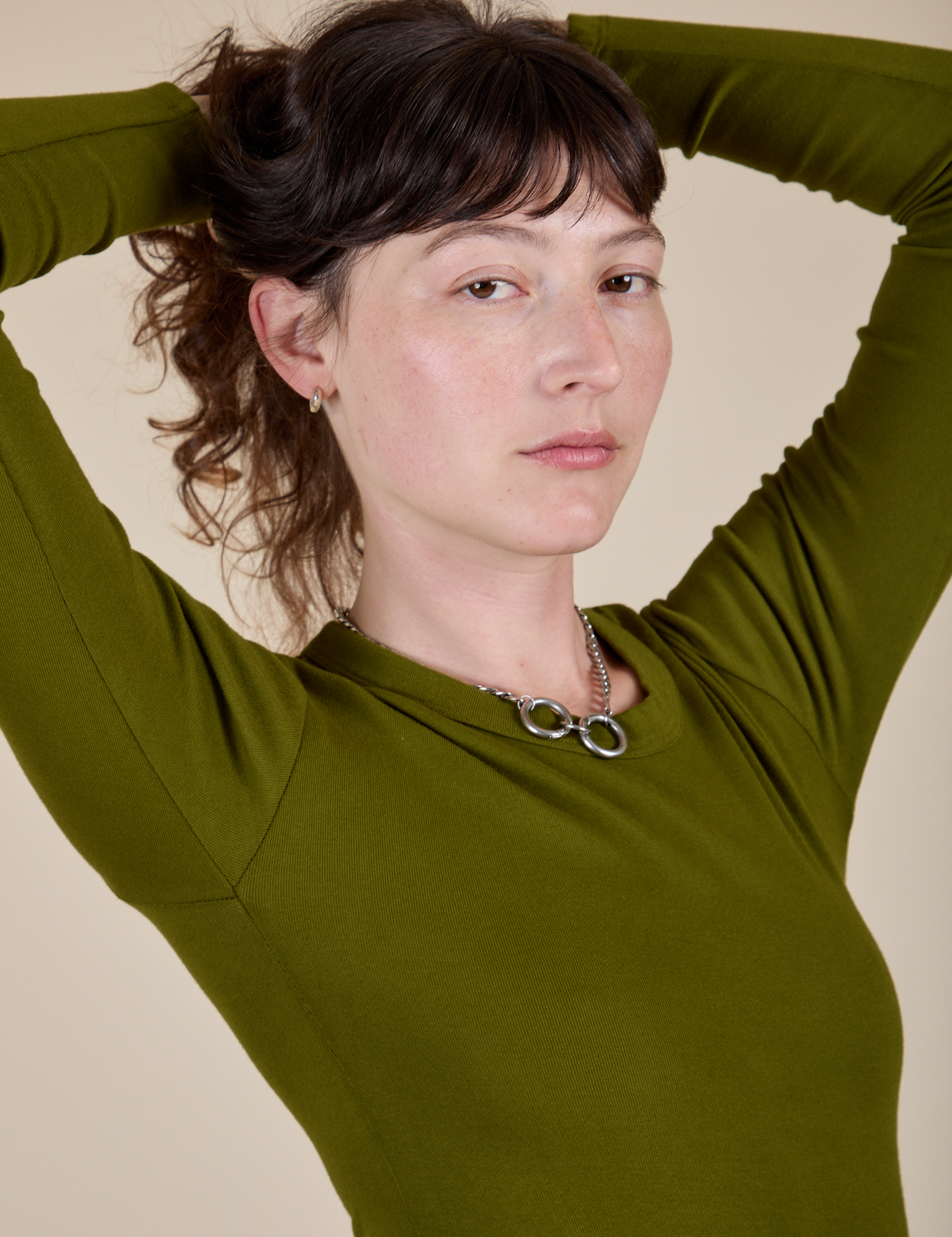 Long Sleeve Baby Tee in Summer Olive angled front view close up on Alex