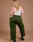 Back view of Organic Action Pants in Evergreen and vintage tee white Cropped Tank on Juliet