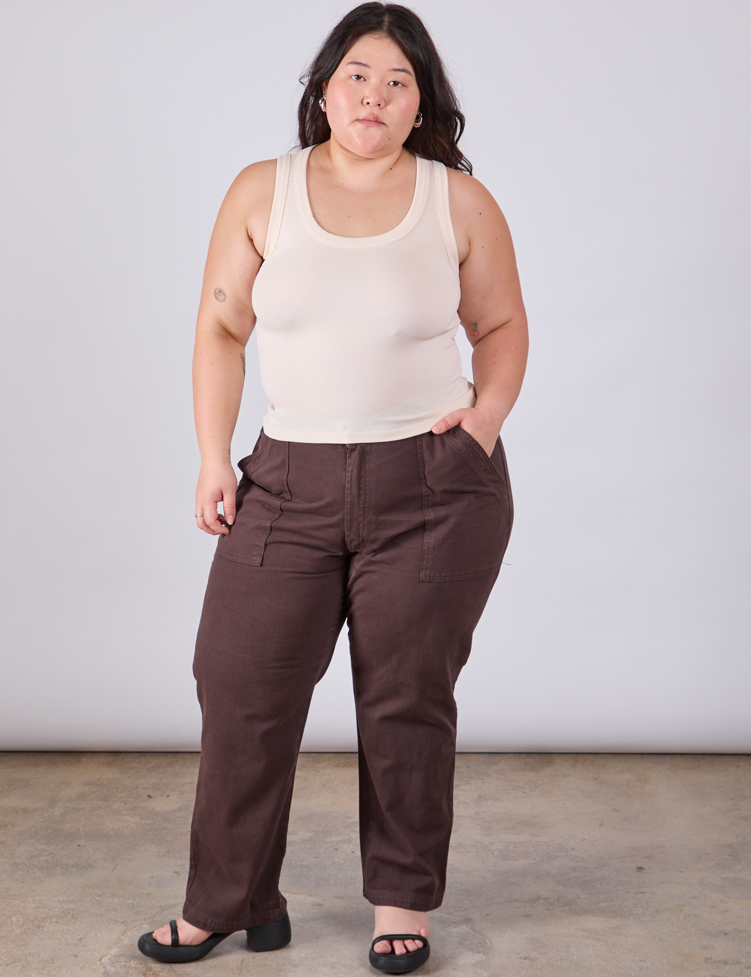 Ashley is wearing Tank Top in Vintage Tee Off-White paired with espresso brown Work Pants