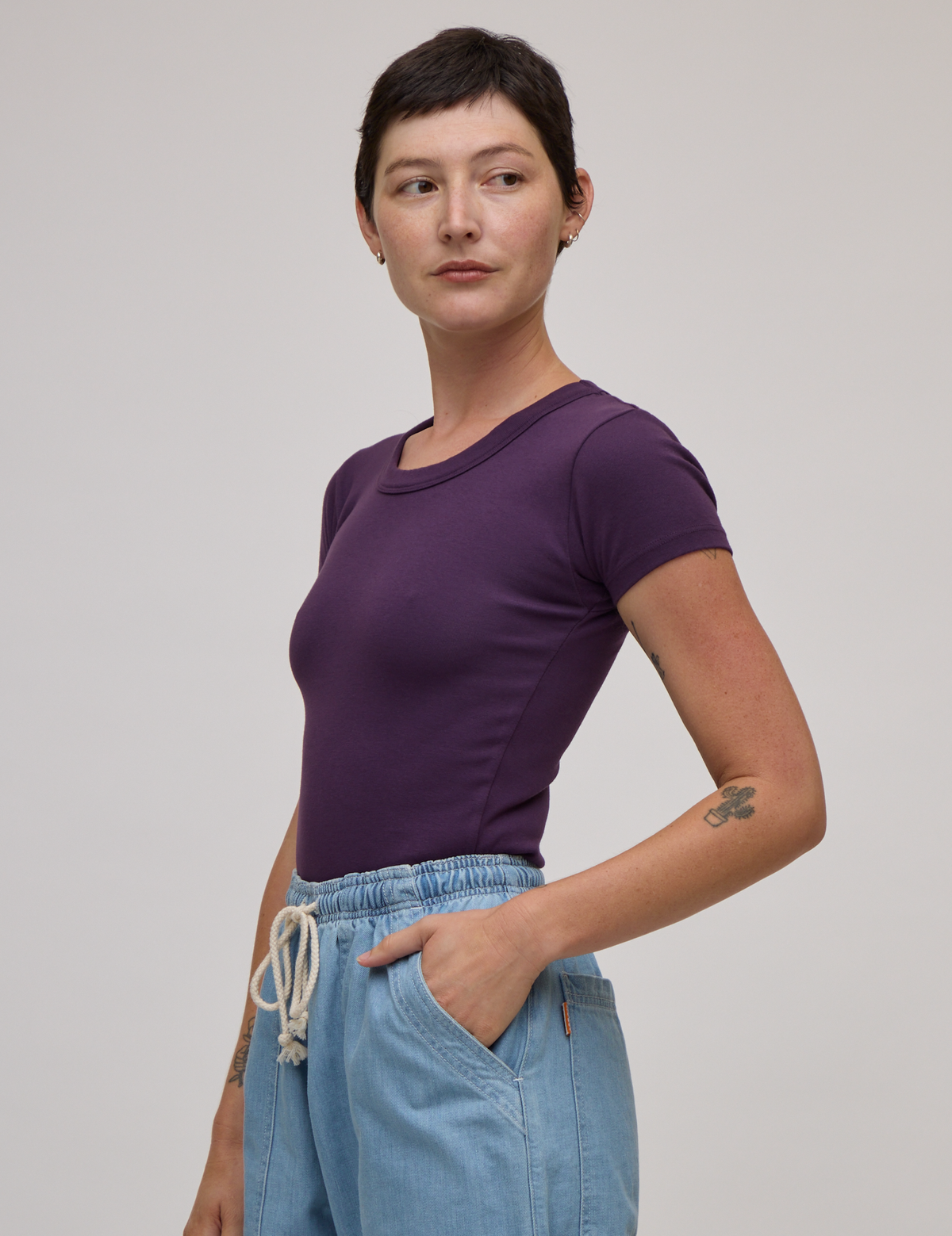 Angled front view of Baby Tee in Nebula Purple on Alex