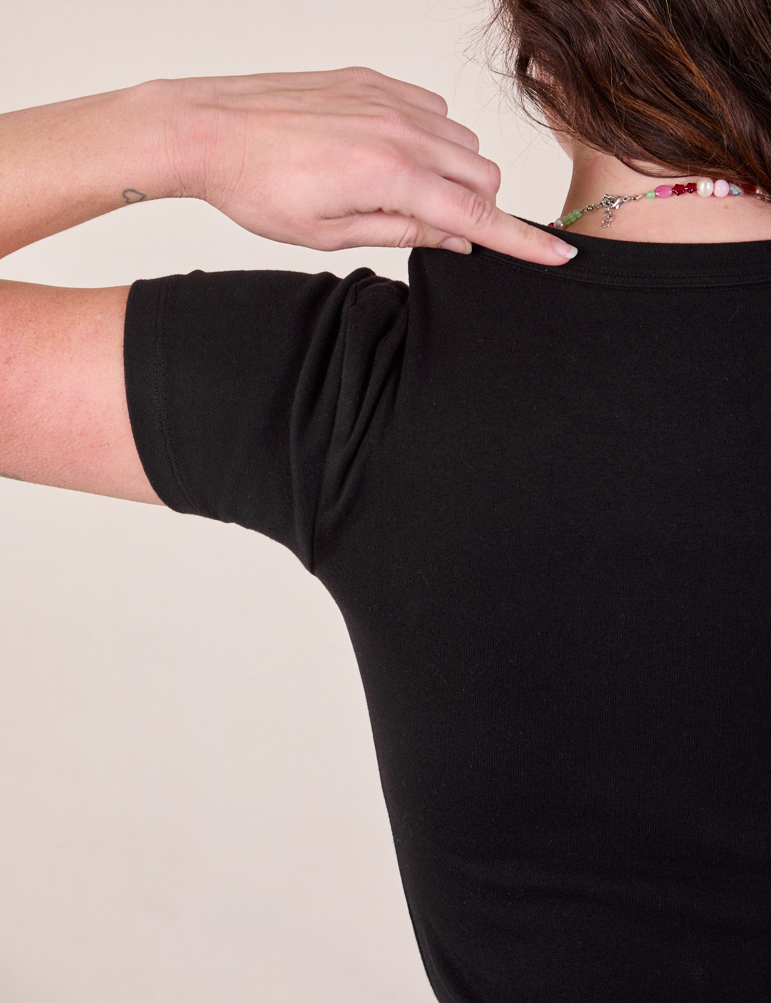 Baby Tee in Vintage Basic Black back shoulder close up on Alex