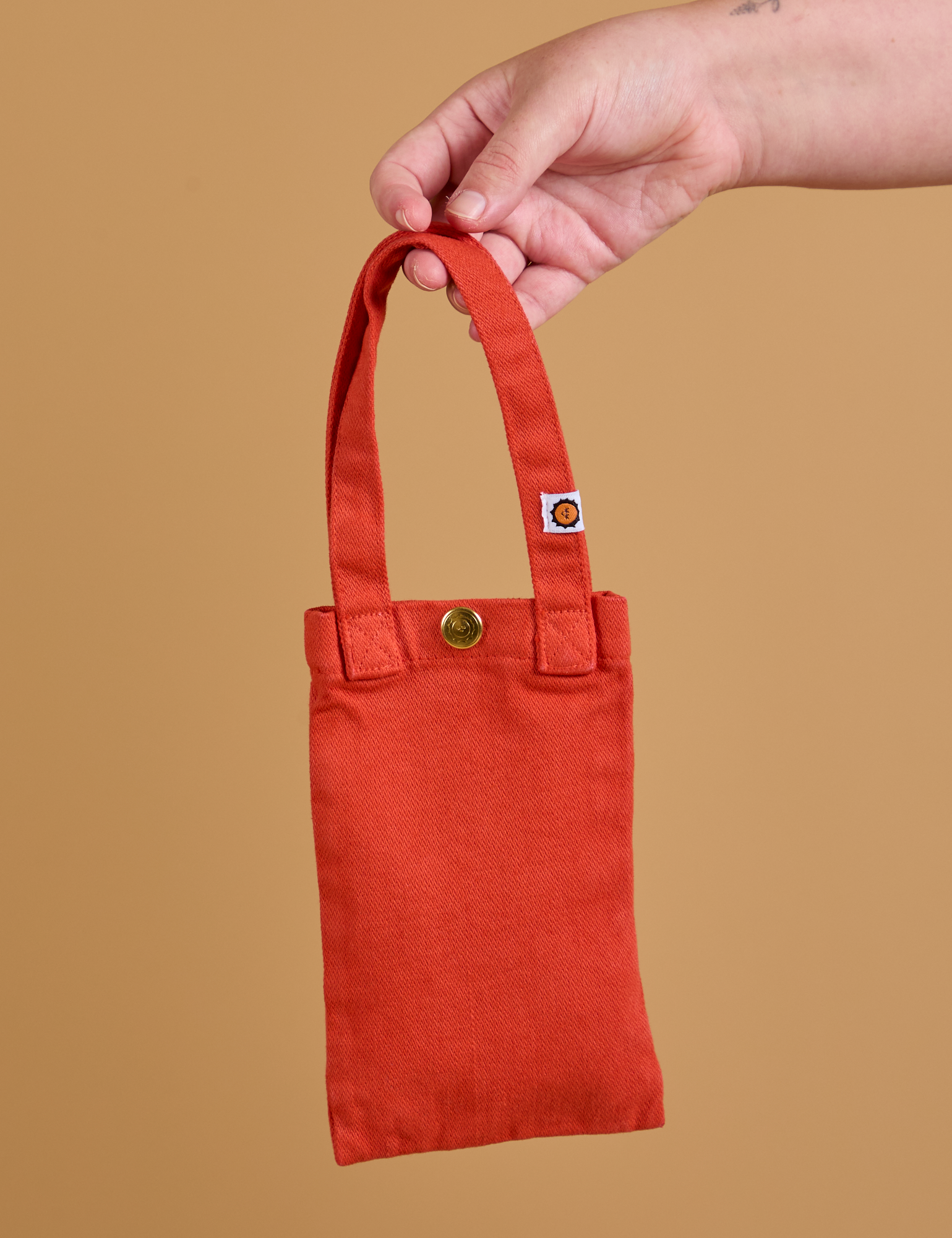 Cell Phone Tote in Mustang Red held by model