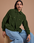 Anthony is wearing a buttoned up Cropped Corduroy Overshirt in Evergreen