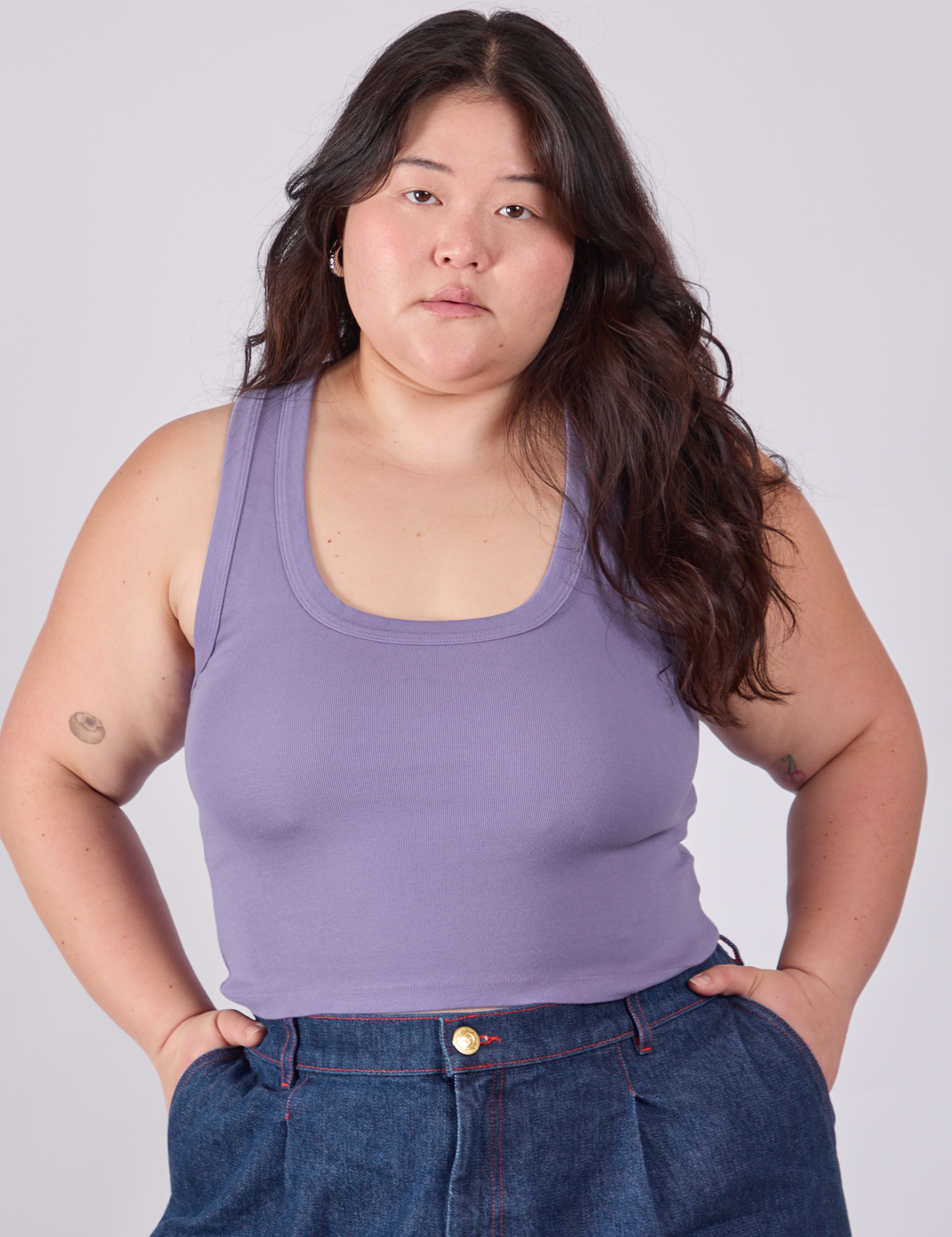 Ashley is 5'7" and wearing L Cropped Tank Top in Faded Grape