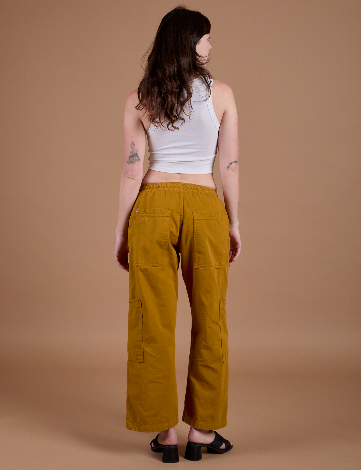 Drop Pocket Cargo Pants in Spicy Mustard back view on Alex