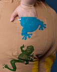 Close up of Ashley's hand in the back pocket of Paintstamped Work Pants in Froggy