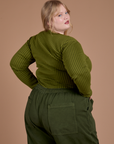 Angled back view of Gingham Long Sleeve Baby Tee in Summer Olive on Juliet