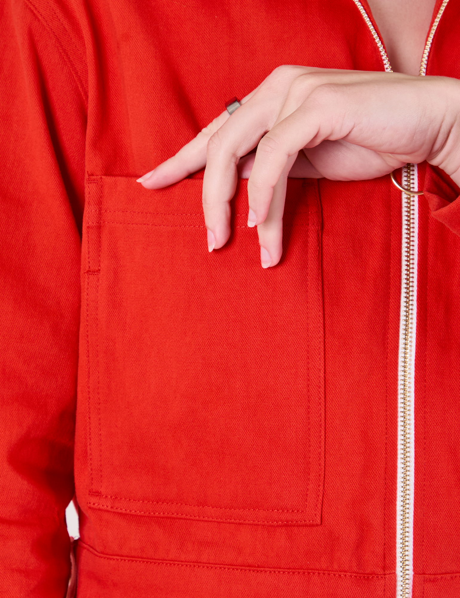 Close up of front pocket of Mechanic Jacket in Mustang Red on Alex