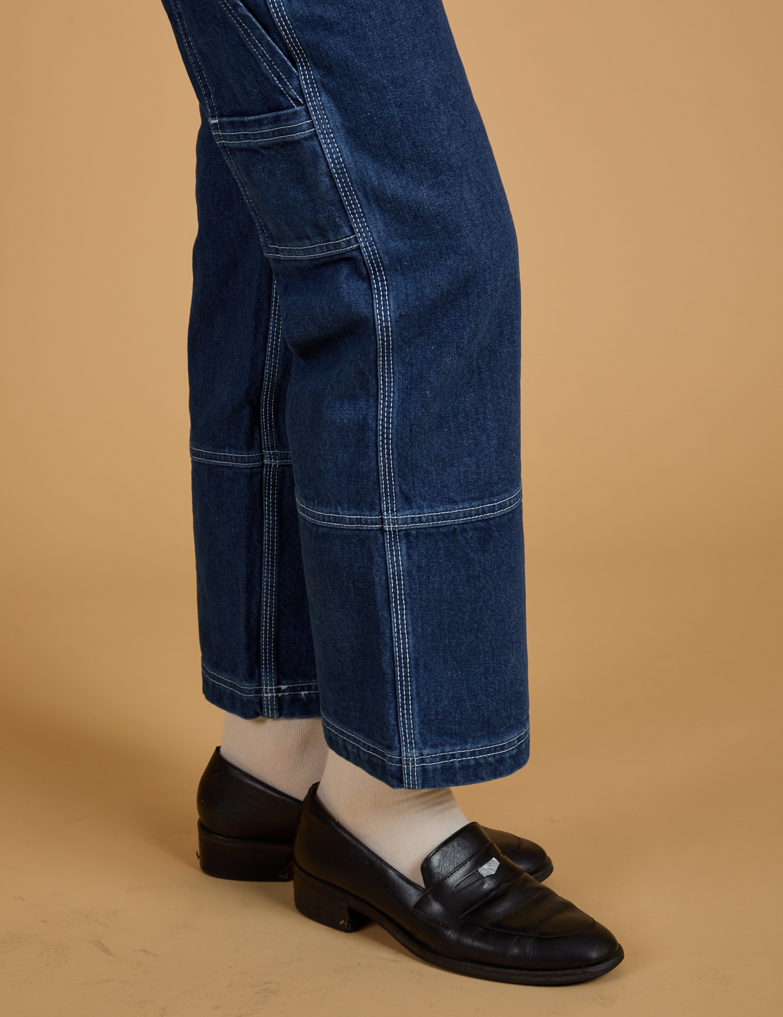 Pant leg side view close up of Mid-Rise Carpenter Jeans in Dark Wash on Alex