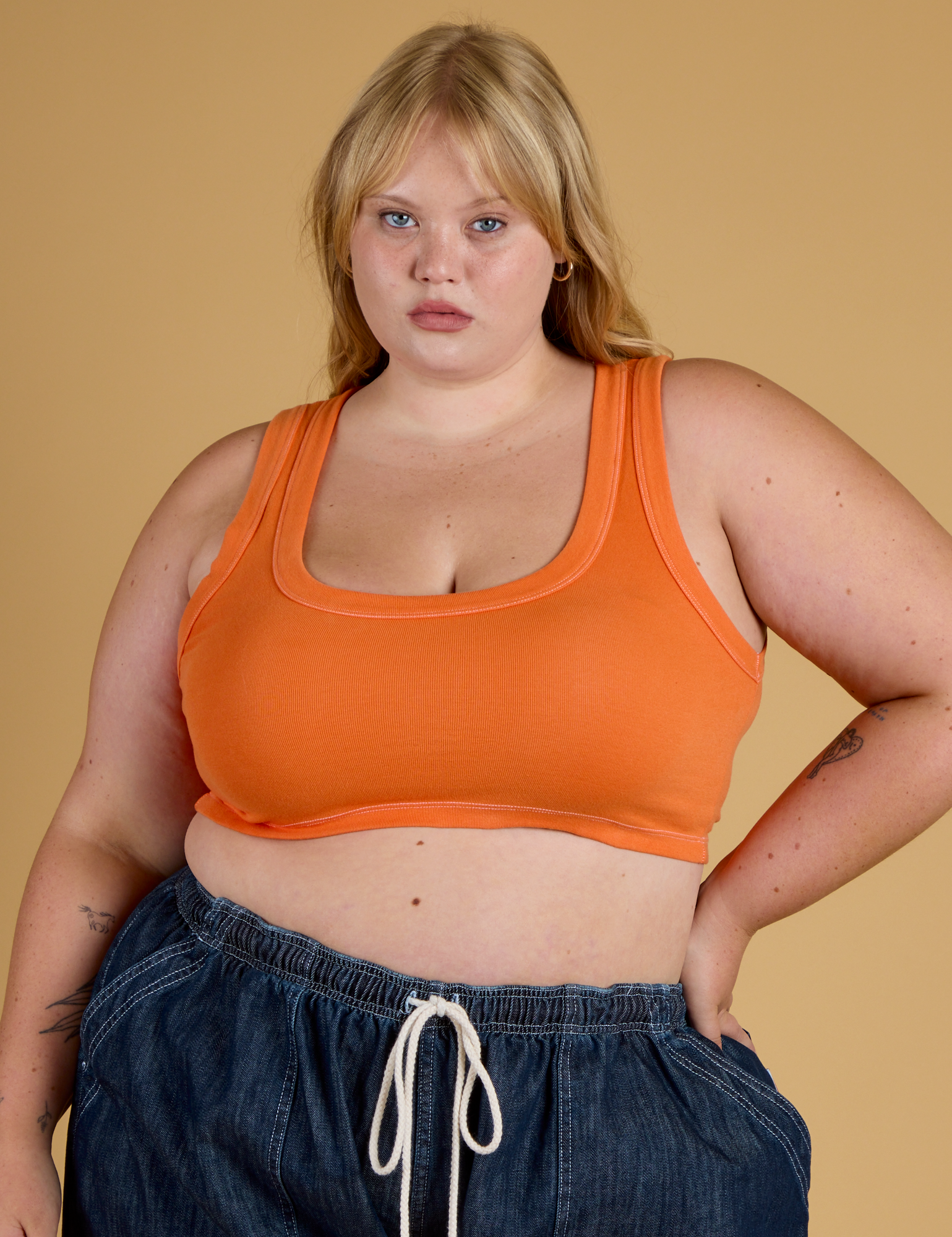 Juliet is 5’7” and wearing L Contrast Stitch Mini Tank in Construction Orange