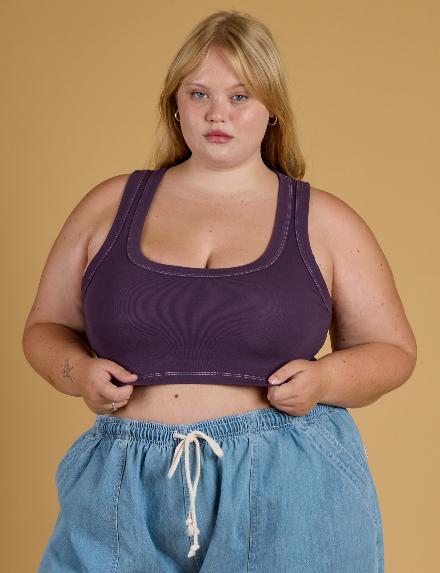 Juliet is 5’7” and wearing L Contrast Stitch Mini Tank in Nebula Purple
