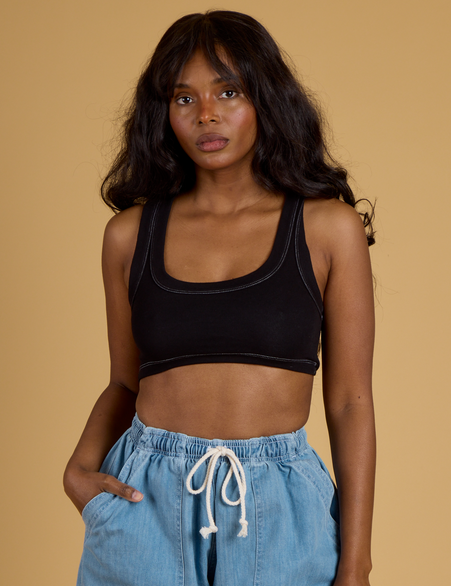 Kandia is 5’3” and wearing P Contrast Stitch Mini Tank in Basic Black