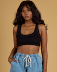 Kandia is 5’3” and wearing P Contrast Stitch Mini Tank in Basic Black