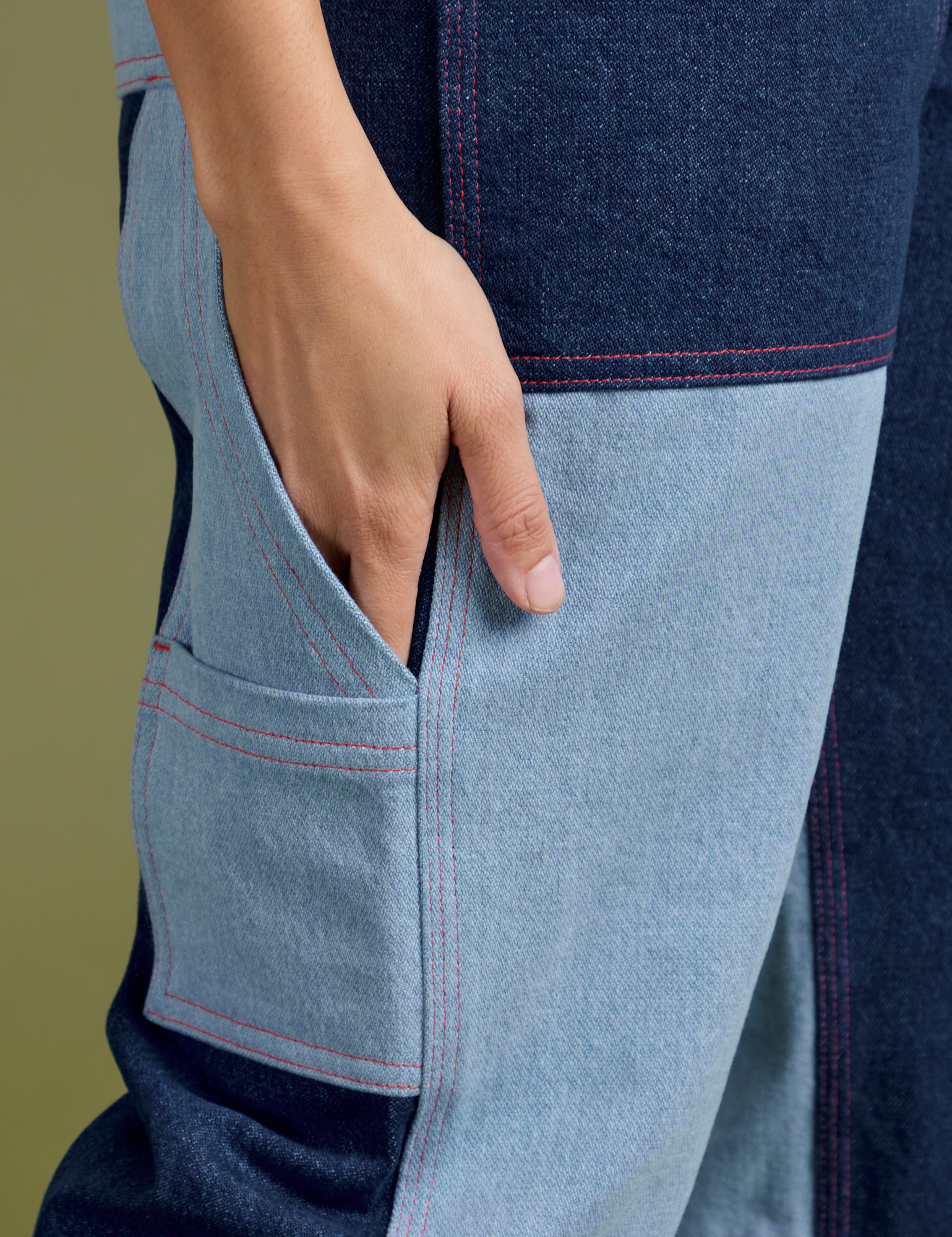Close up of Tiara's hand in the side leg pocket of Mismatched Denim Carpenter Jeans