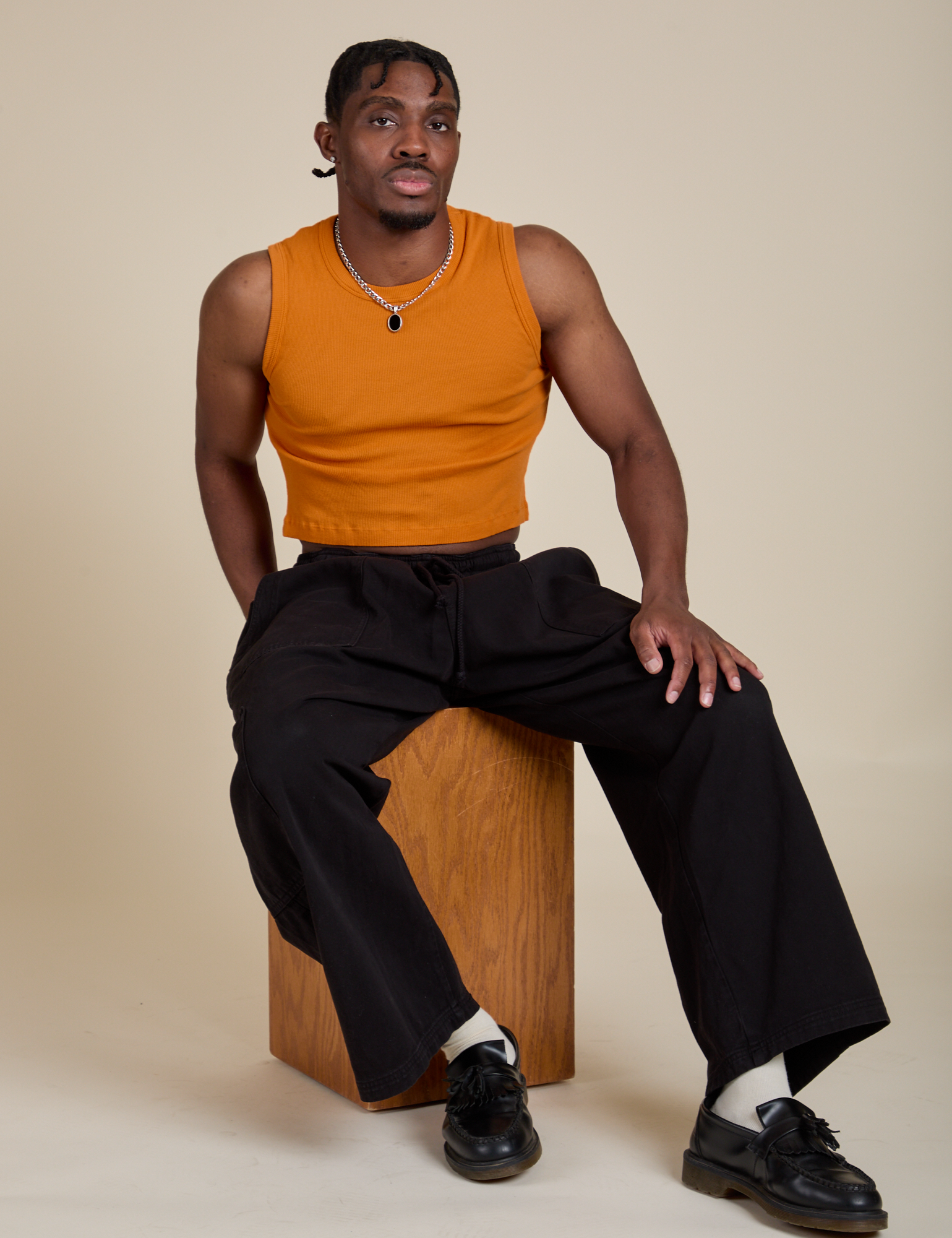 Muscle Tee in Creamsicle Orange and black Drop Pocket Cargo Pants on Isaac