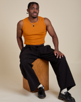 Muscle Tee in Creamsicle Orange and black Drop Pocket Cargo Pants on Isaac