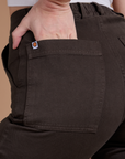 Close up of Alex's hand in the back pocket of Organic Work Pants in Espresso Brown