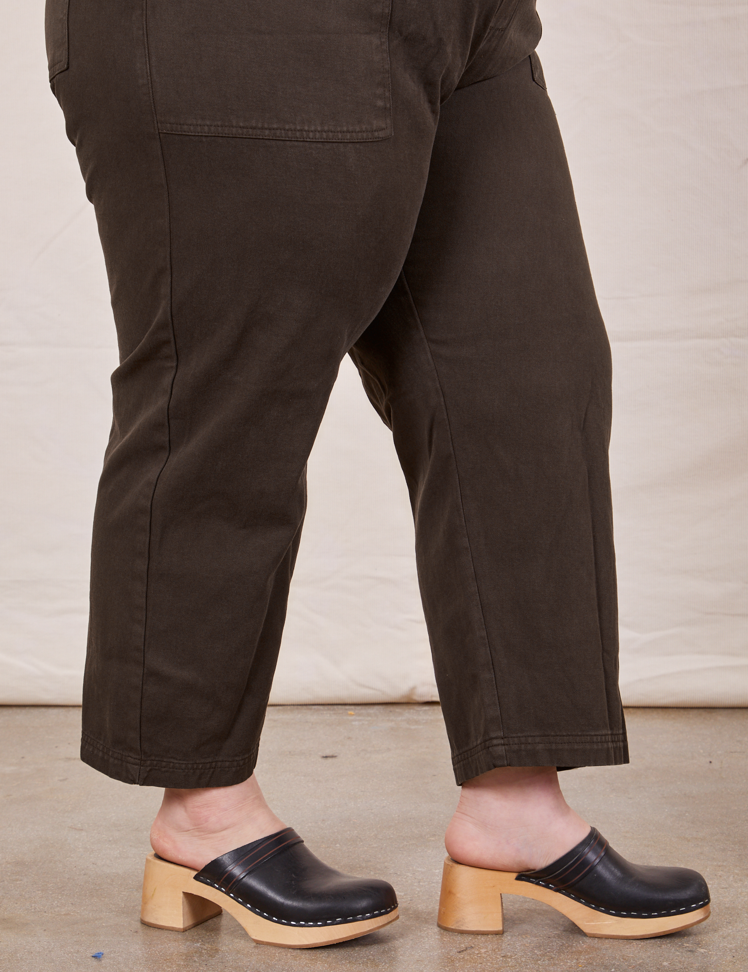 Pant leg side view of Petite Short Sleeve Jumpsuit in Espresso Brown worn by Ashley