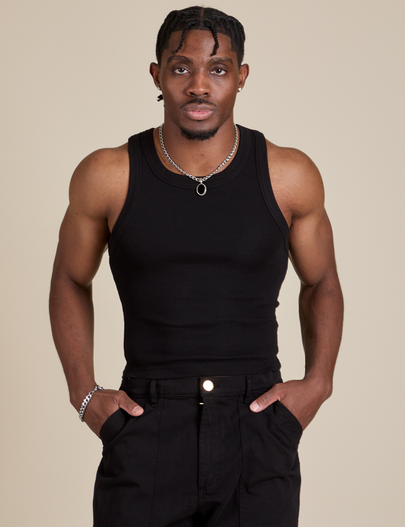 Isaac is 5’10” and wearing S Racerback Tank in Black