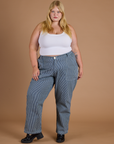 Juliet is 5’7” and wearing 2XL Railroad Denim Work Pants in Natural paired with vintage tee white Cropped Tank