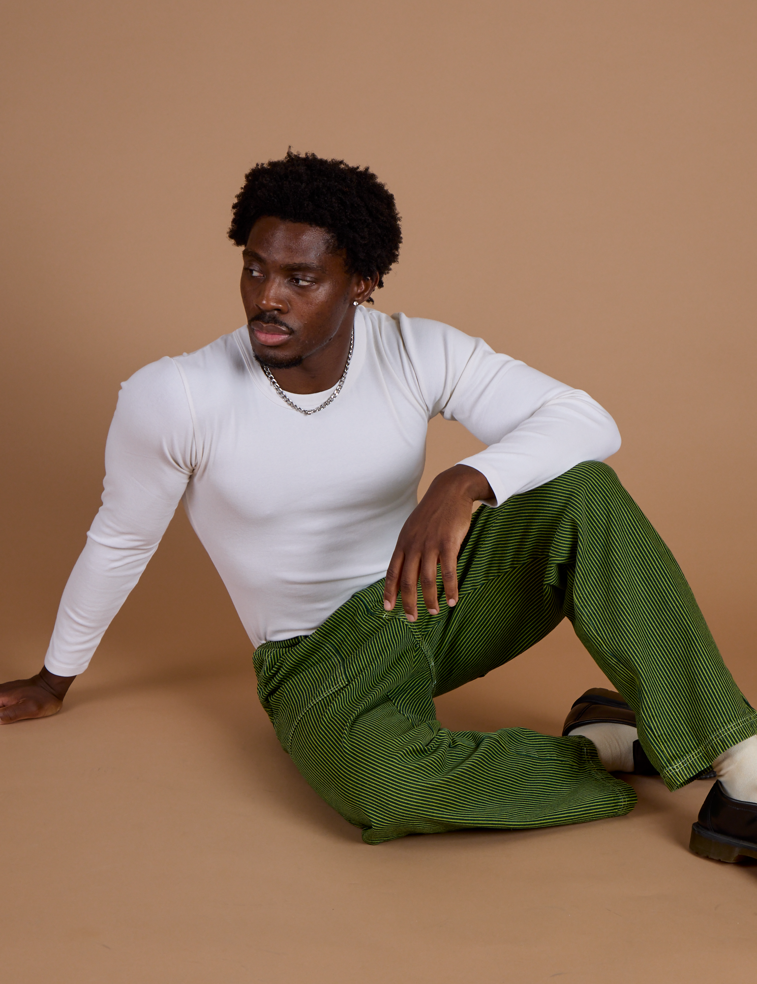 Railroad Denim Work Pants in Gross Green Overdye and vintage tee white long sleeve baby tee on Isaac