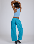Back view of Drop Pocket Cargo Pants in Hawaiian Blue and baby blue Racerback Tank on Kira
