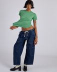 Kira is wearing Jr. Varsity Tee in Seafoam Green and dark wash Denim Drop Pocket Pants