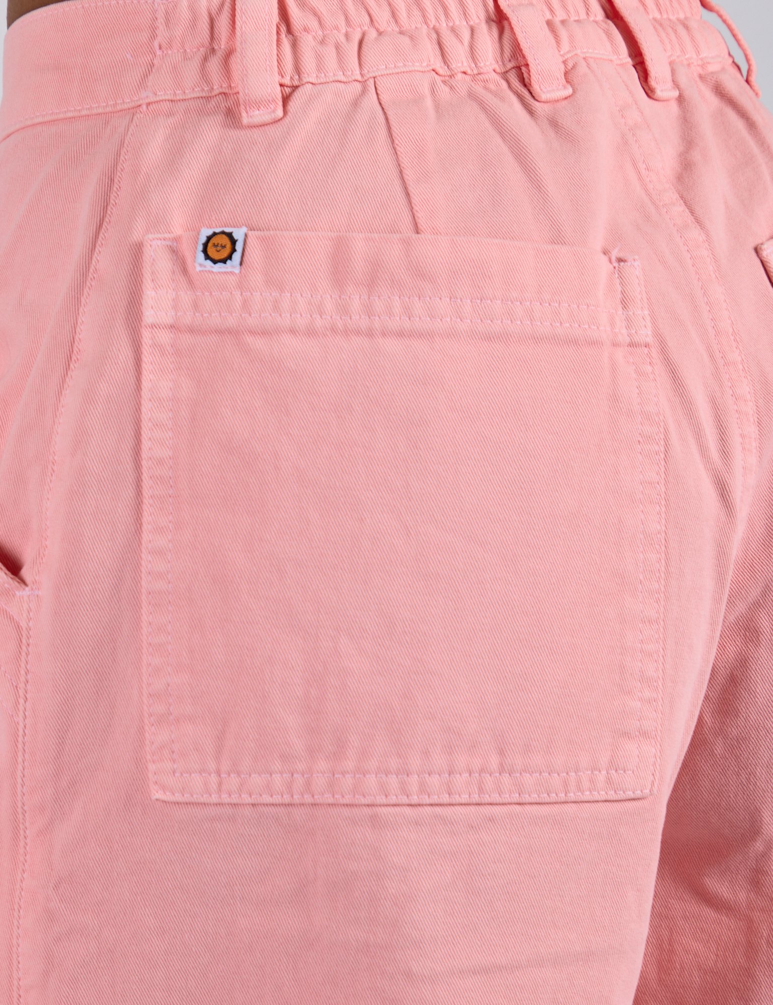 Close up of Longline Work Shorts in Baby Pink back pocket