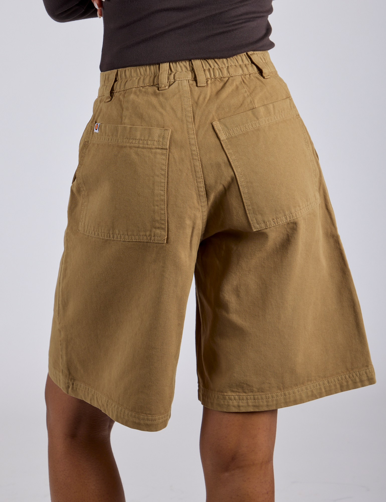 Longline Work Shorts in Desert Brown back view on Kira