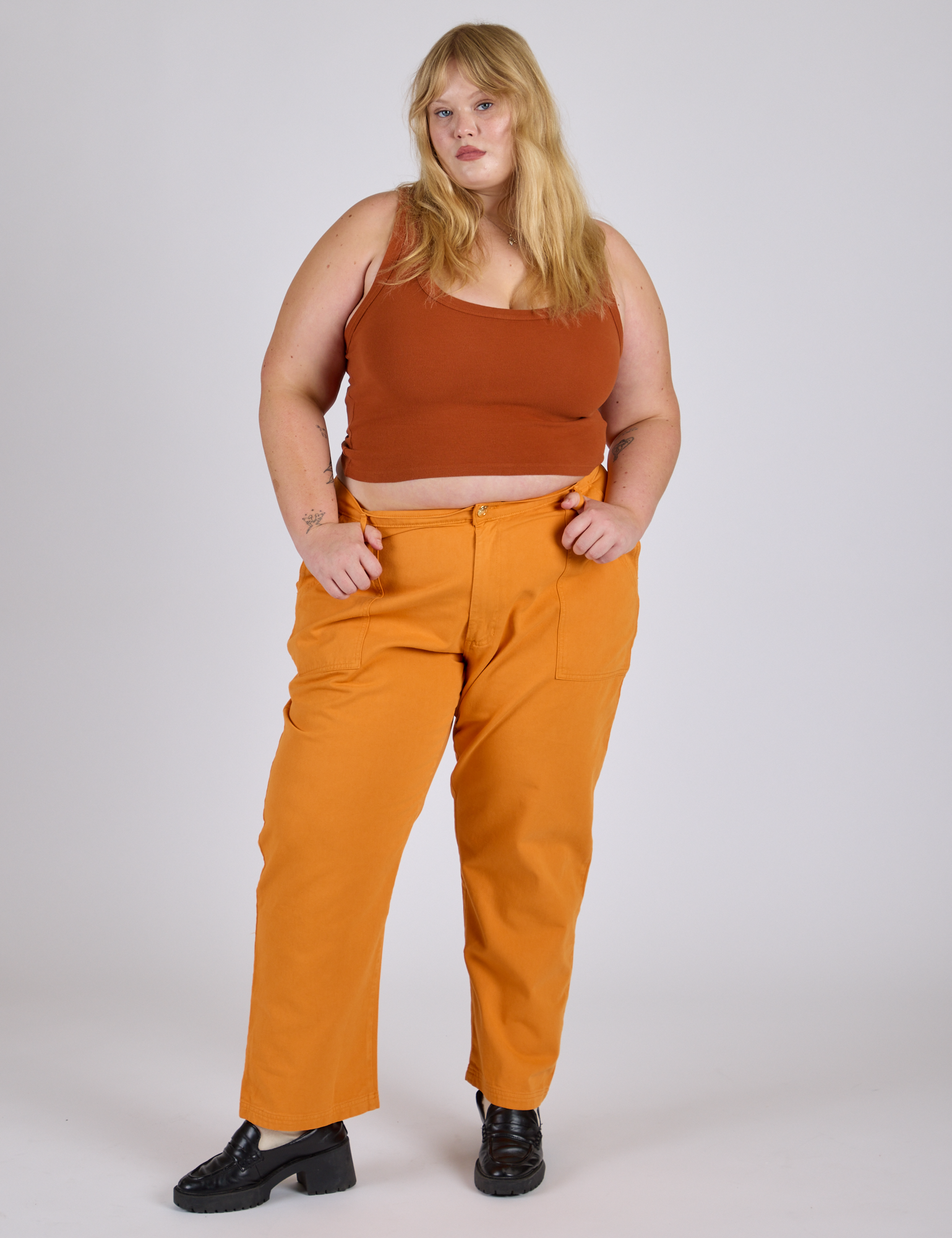 Juliet is 5’7” and wearing 2XL Work Pants in Creamsicle Orange paired with burnt terrracotta Cropped Tank