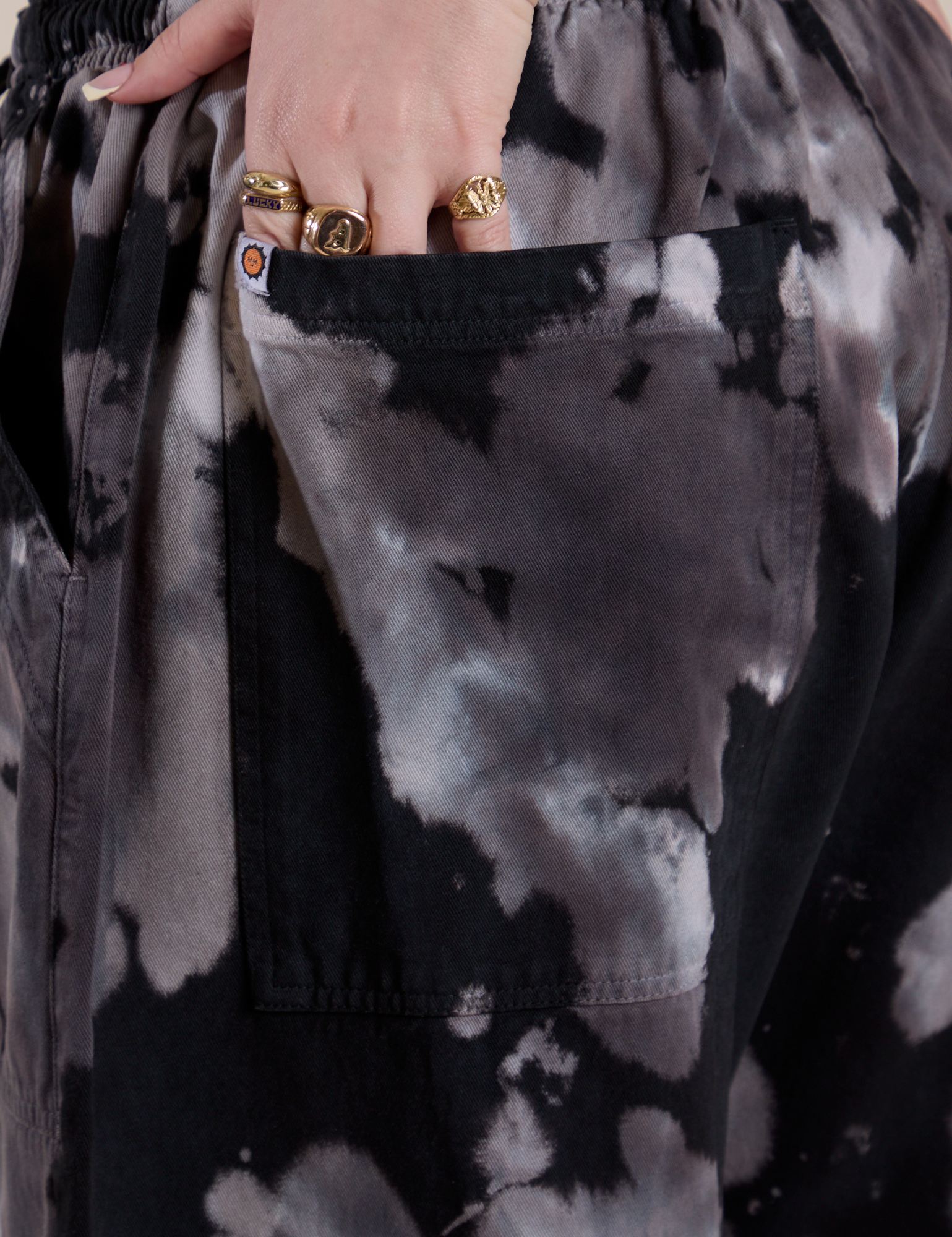 Close up of Sydney's hand in the back pocket of Magic Waters Drop Pocket Pants in Ink Blot