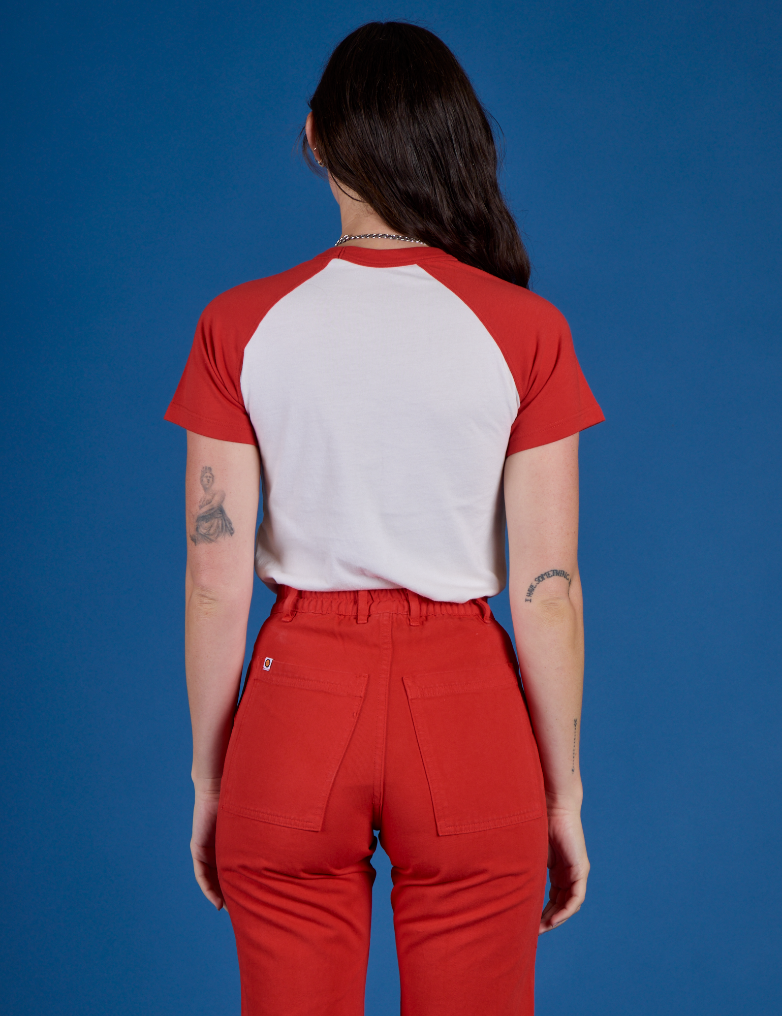 Back view of Produce Raglan Tee in Tomato on Alex