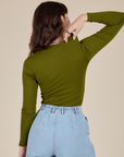 Long Sleeve Baby Tee in Summer Olive back view on Alex