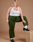 Juliet is wearing Organic Action Pants in Evergreen and vintage tee white Cropped Tank
