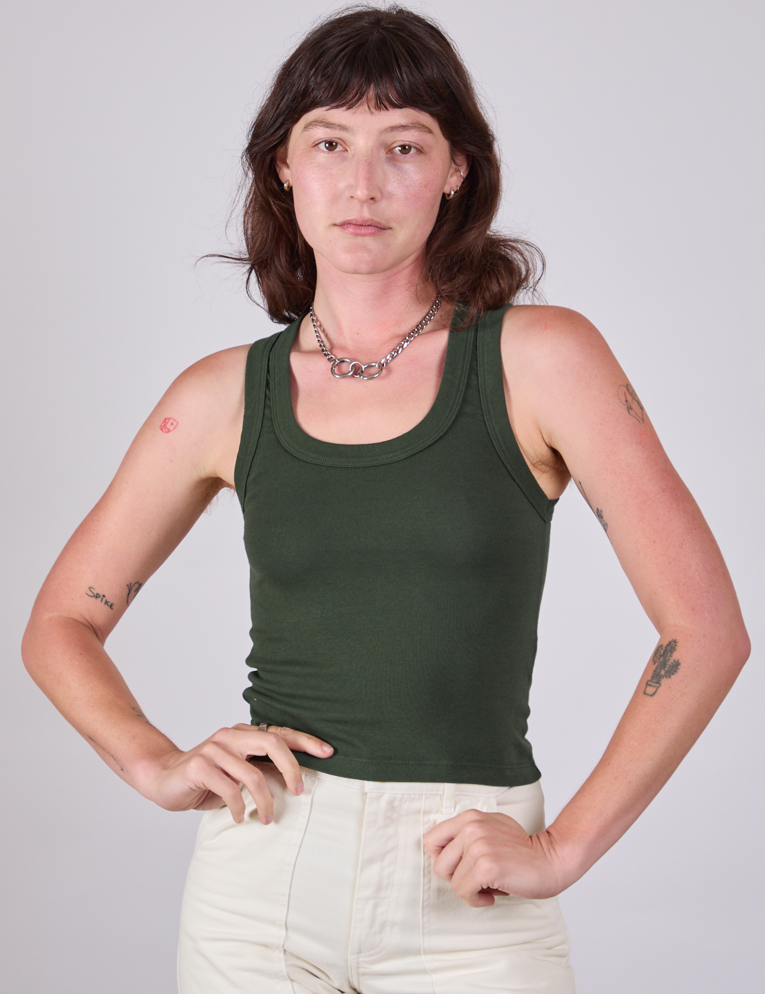 Alex is 5'8" and wearing P Tank Top in Swamp Green
