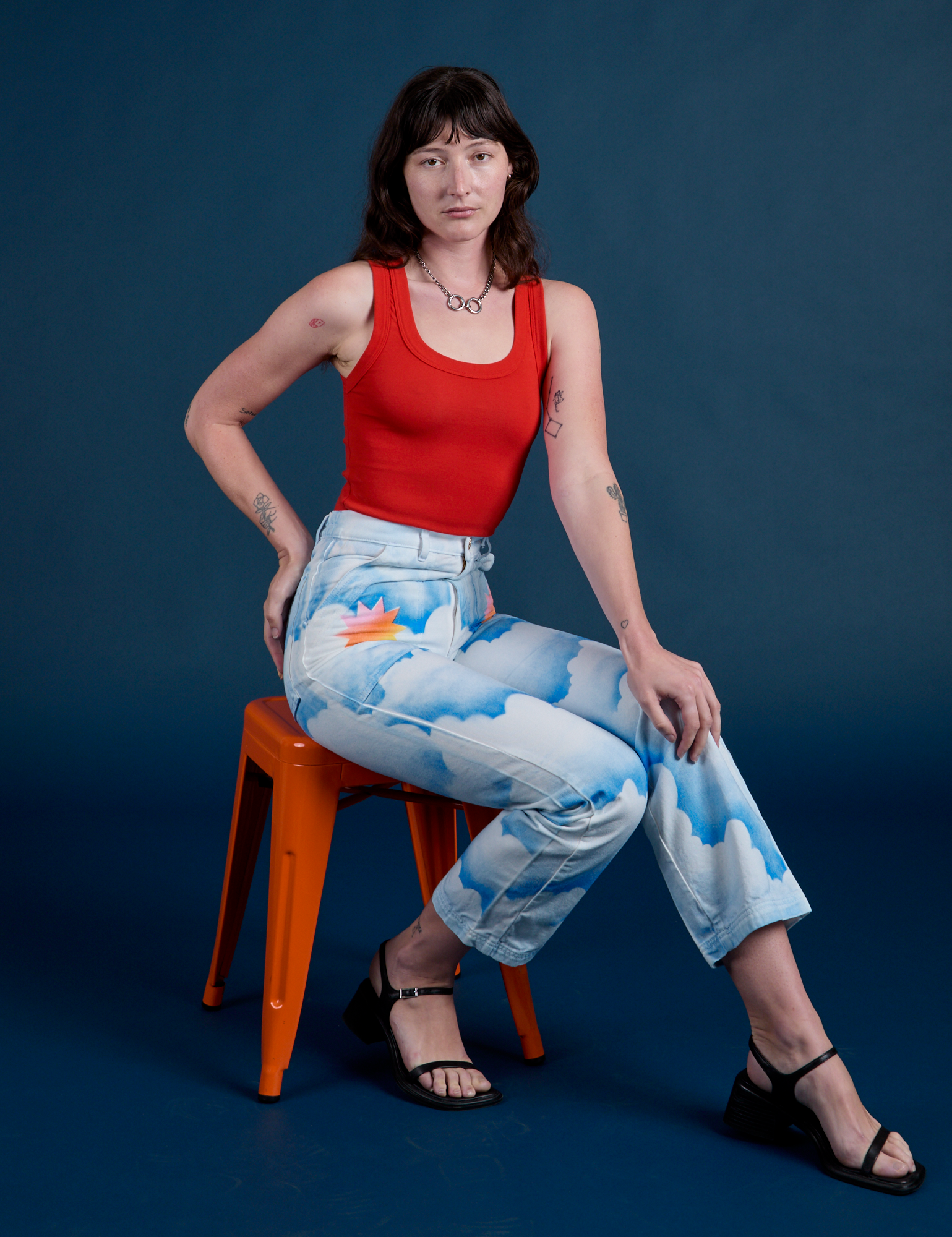 Work Pants in Sunny Cloud Airbrush and mustang red Tank Top on Alex