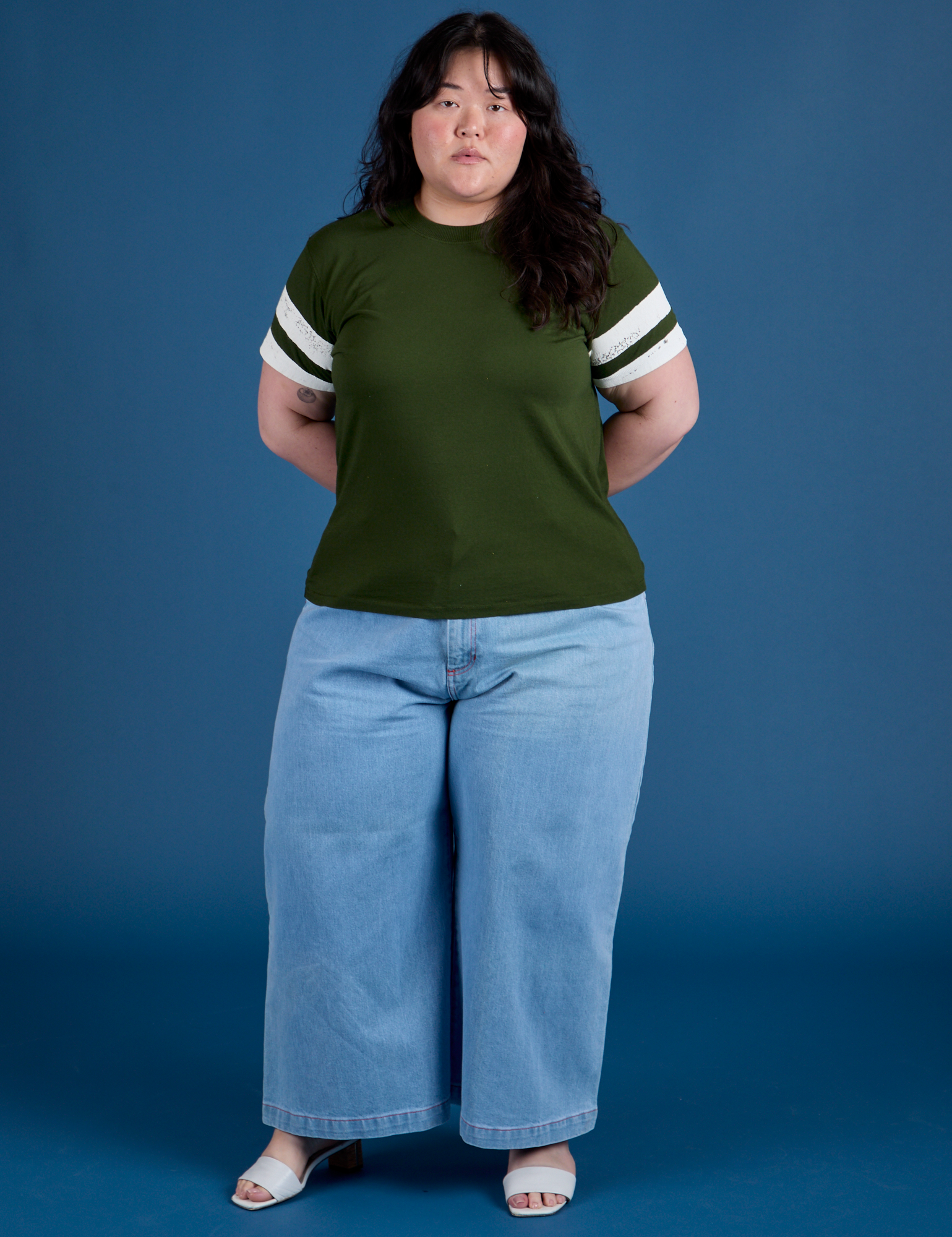 Ashley is 5’7” and wearing L Painted Vintage Tee in Evergreen paired with light wash Wide Leg Trousers