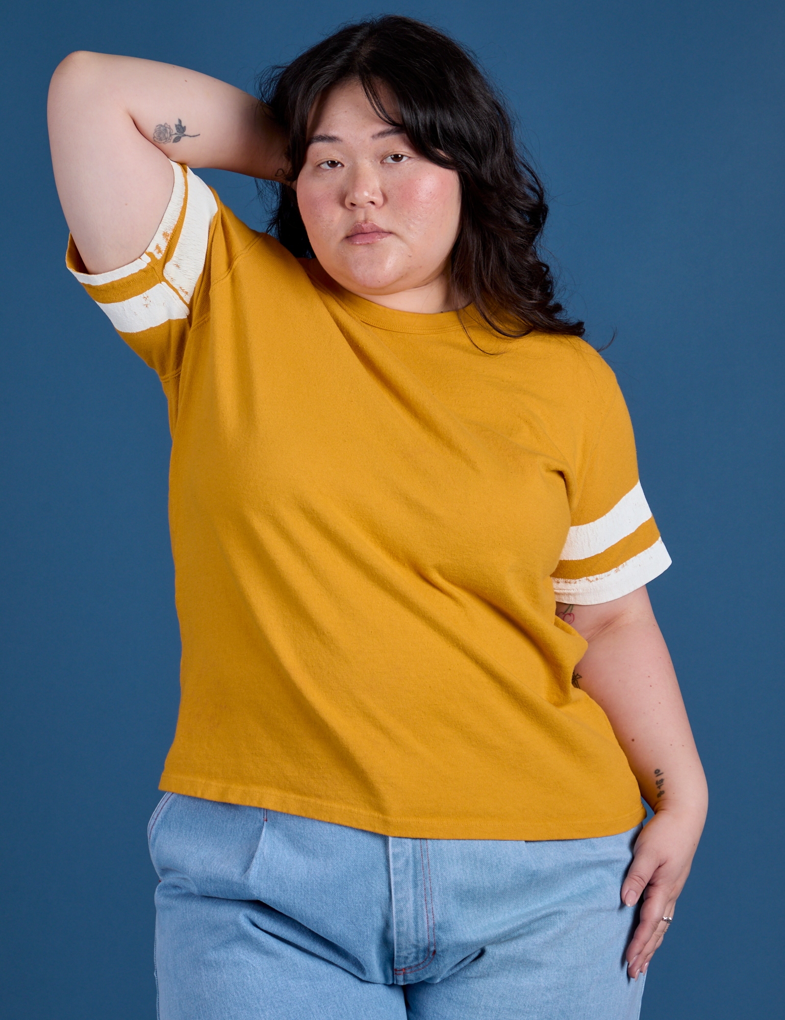Ashley is 5’7” and wearing L Painted Burly Tee in Mustard Yellow