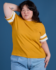 Ashley is 5’7” and wearing L Painted Burly Tee in Mustard Yellow