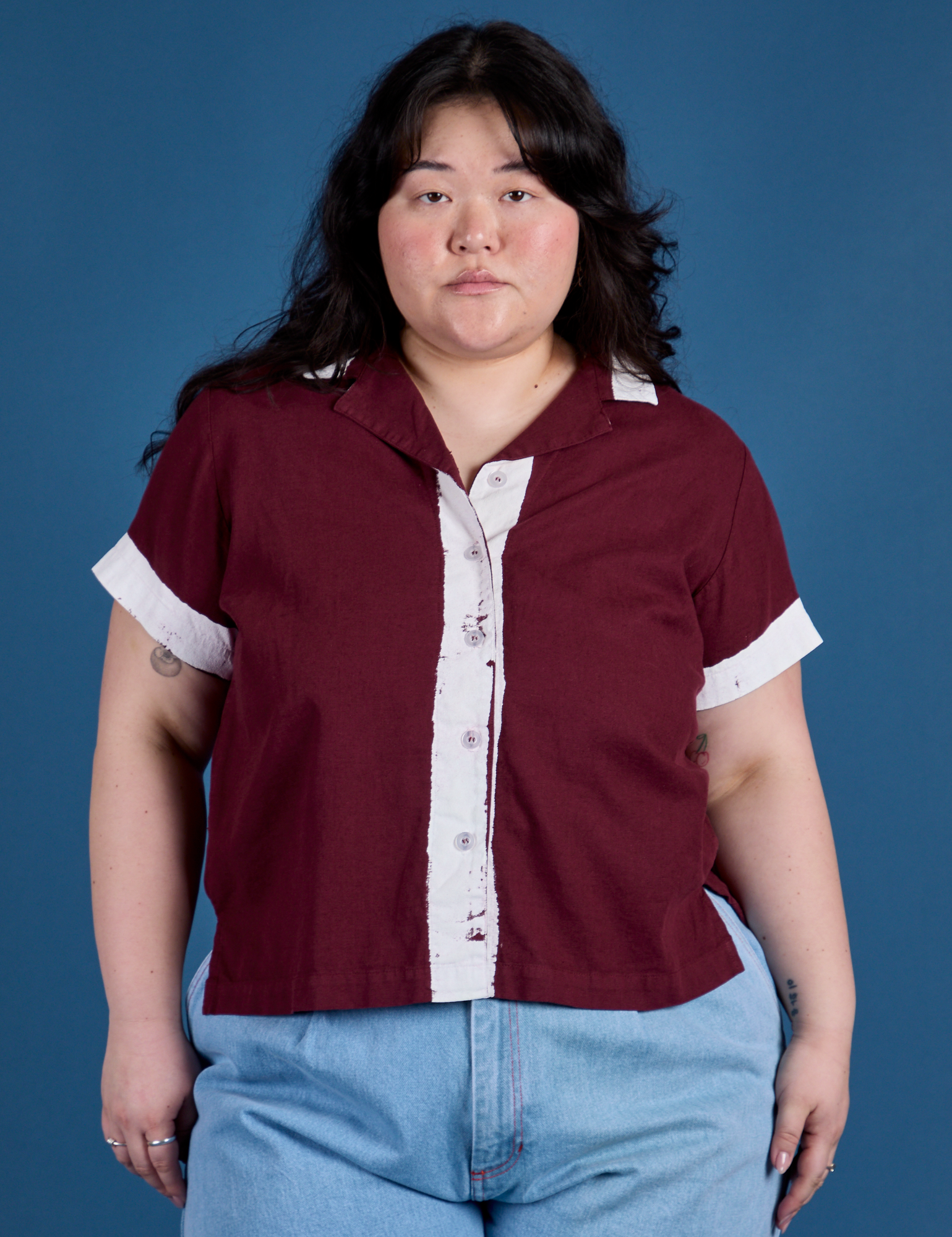 Ashley is 5’7” and wearing L Painted Pantry Button-Up in Red Wine
