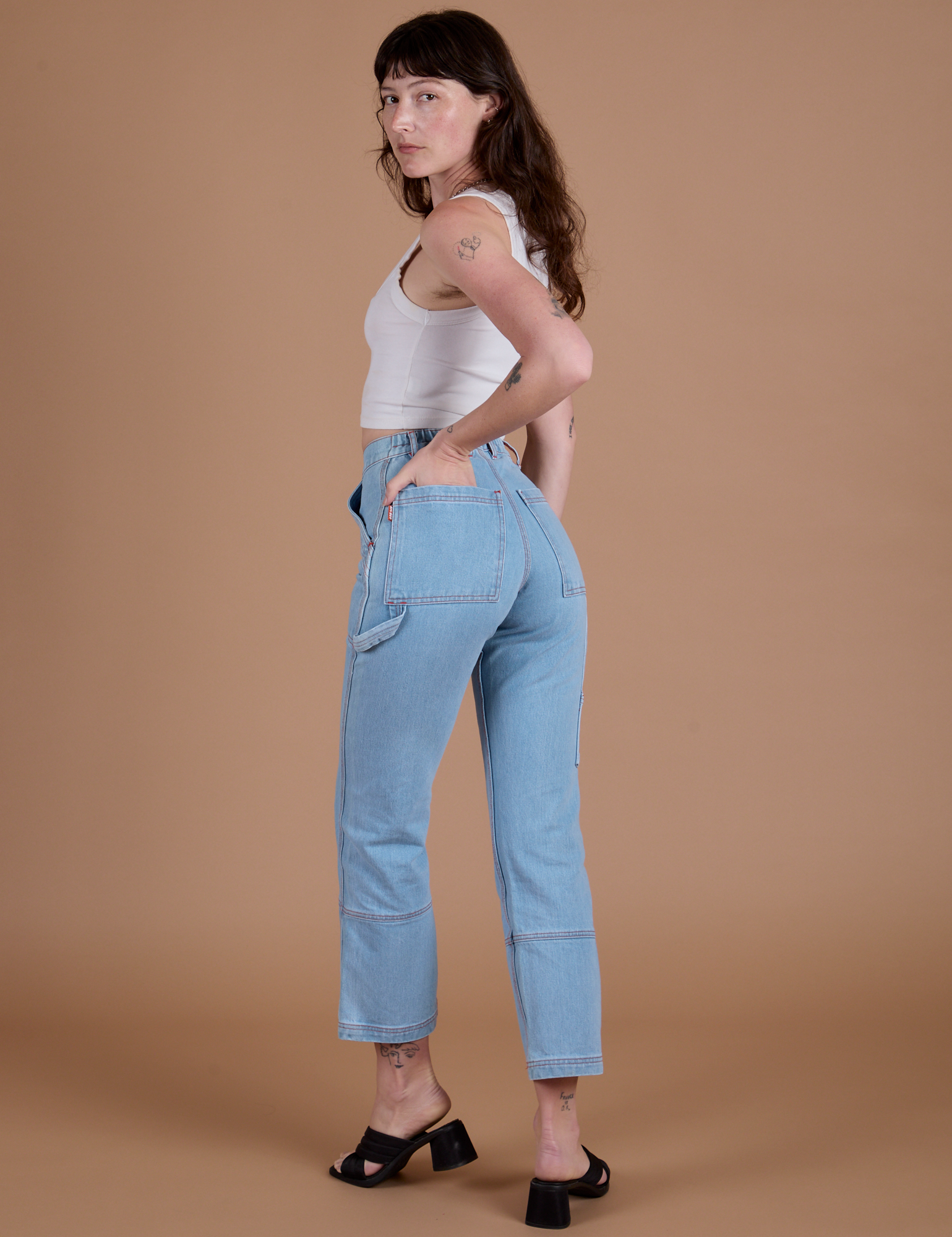 Carpenter Jeans in Light Wash angled back view on Alex