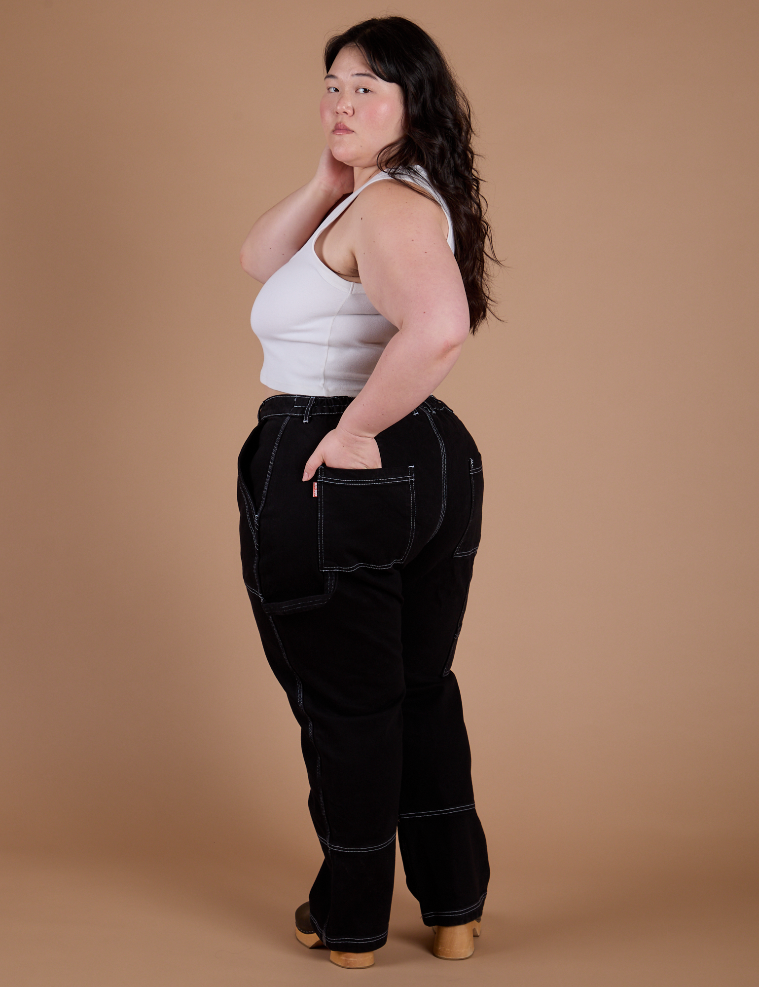 Angled back view of Carpenter Jeans in Black on Ashley