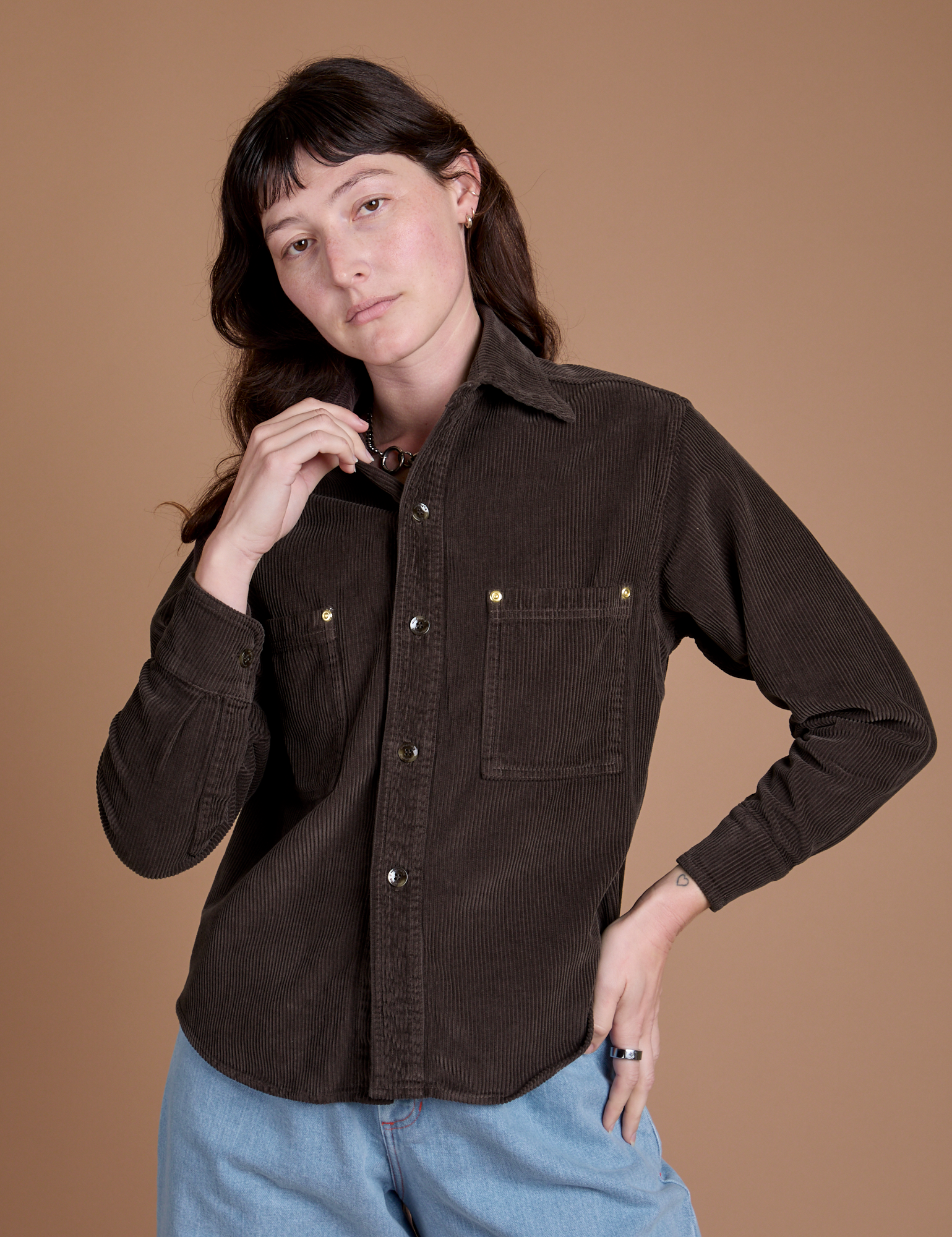 Alex is wearing a buttoned up Cropped Corduroy Overshirt in Espresso Brown