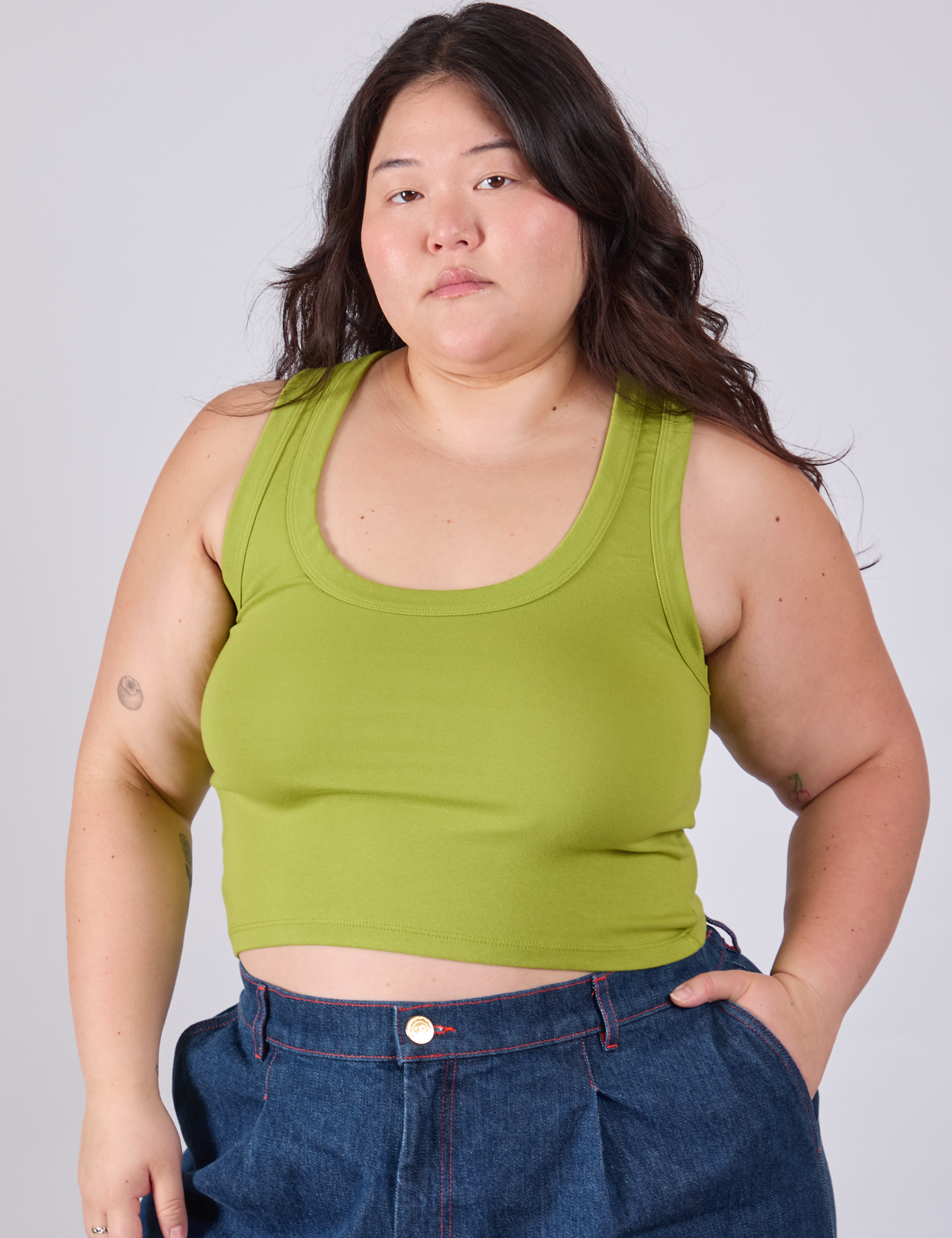 Ashley is 5'7" and wearing L Cropped Tank Top in Gross Green