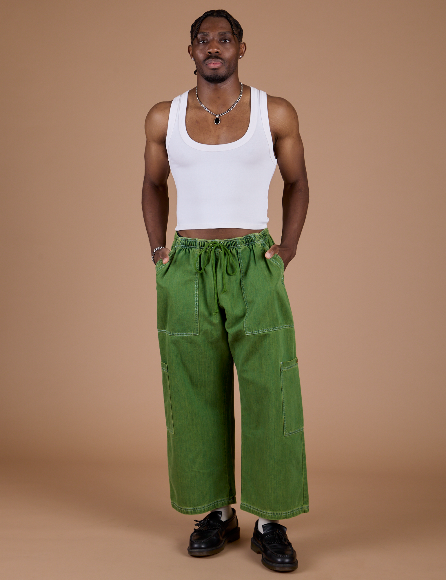 Isaac is 5’10” and wearing M Denim Drop Pocket Pants in Green Overdye paired with vintage tee white Cropped Tank