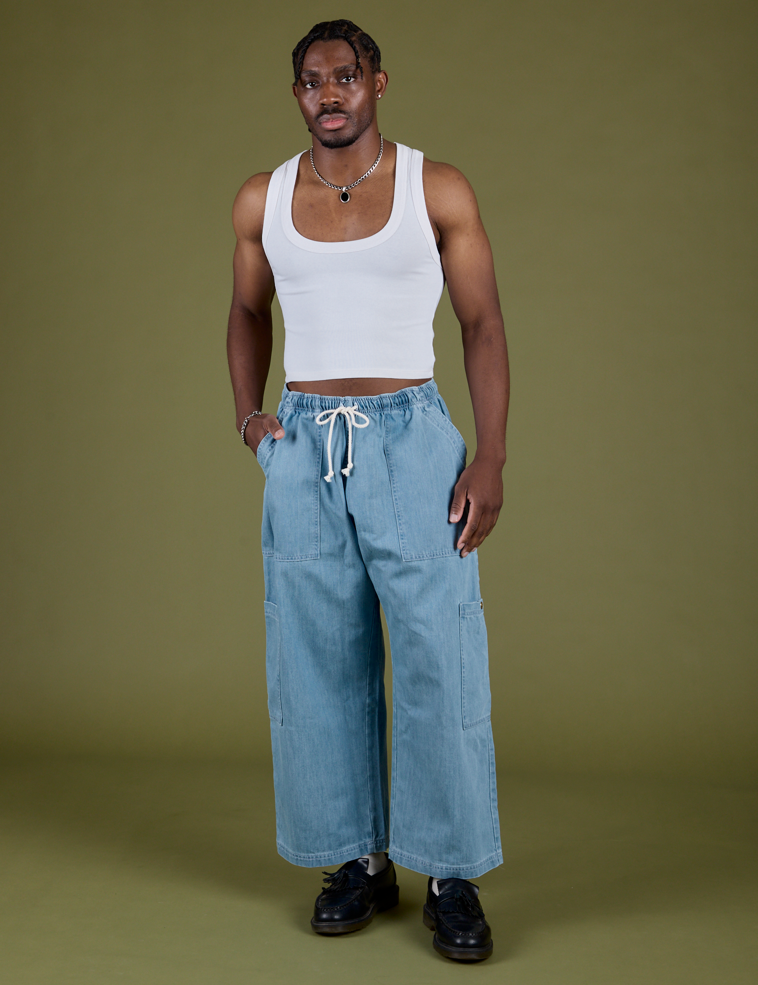 Isaac is 5’10” and wearing M Denim Drop Pocket Pants in Light Wash paired with vintage tee white Cropped Tank