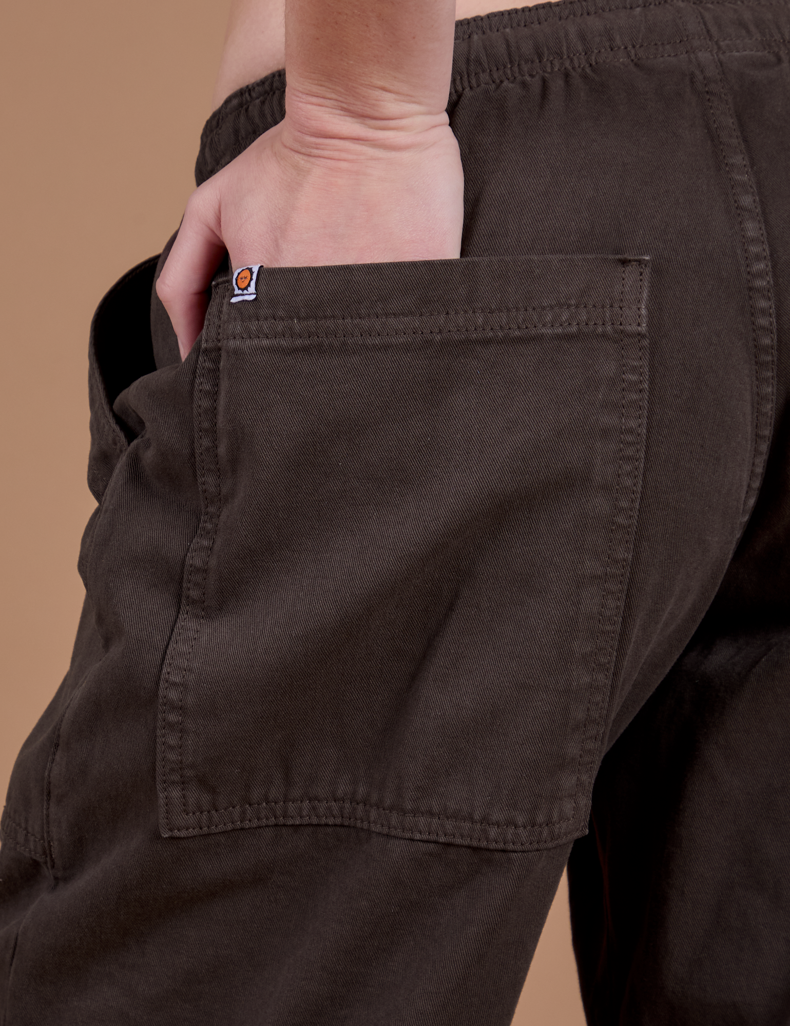 Close up of Ashley's hand in the back pocket of Drop Pocket Cargo Pants in Espresso Brown 
