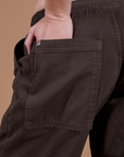 Close up of Ashley's hand in the back pocket of Drop Pocket Cargo Pants in Espresso Brown 