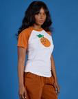 Angled front view of Produce Raglan Tee in Orange on Kandia