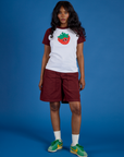 Kandia is 5’3” and wearing P Produce Raglan Tee in Strawberry